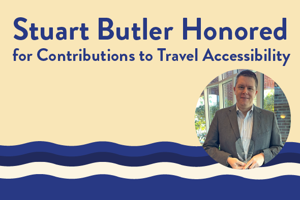 Stuart Butler smiles with award from CAN.