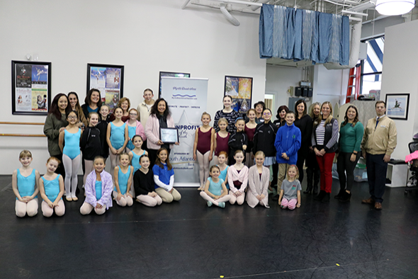 Coastal Youth Ballet Theatre teachers and students smile and hold award plaque