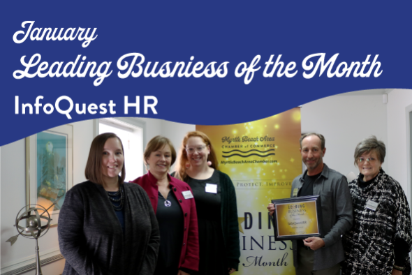 info quest employees smile with award plaque