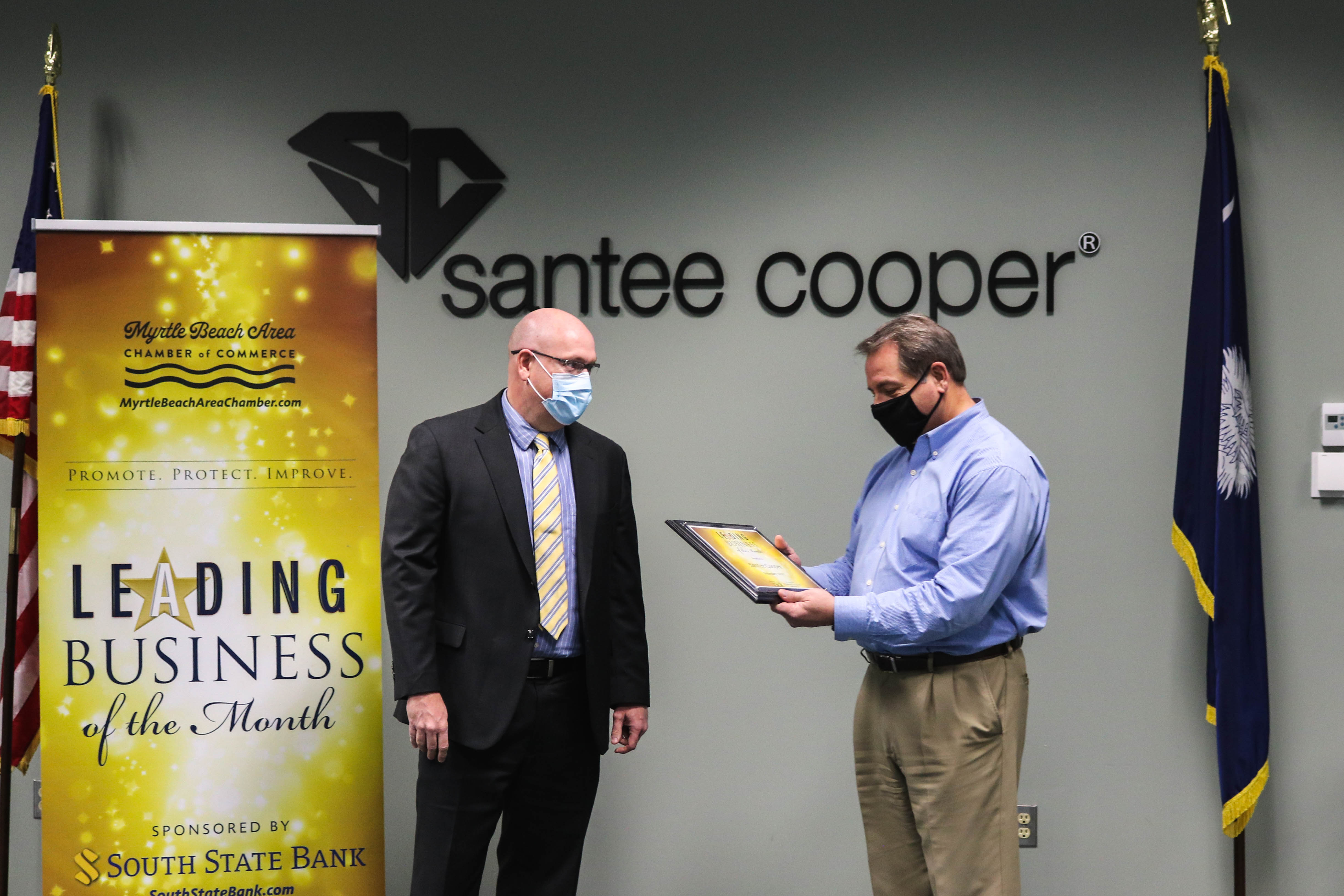 brian lewis with santee cooper receives award plaque from south state bank
