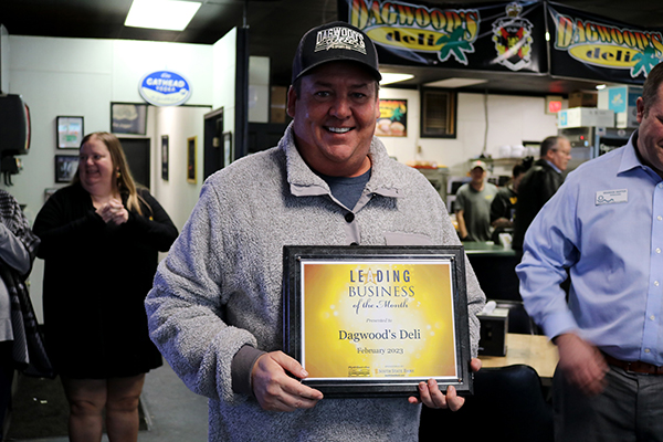 Jon Staton smiles with Leading Business of the Month plaque