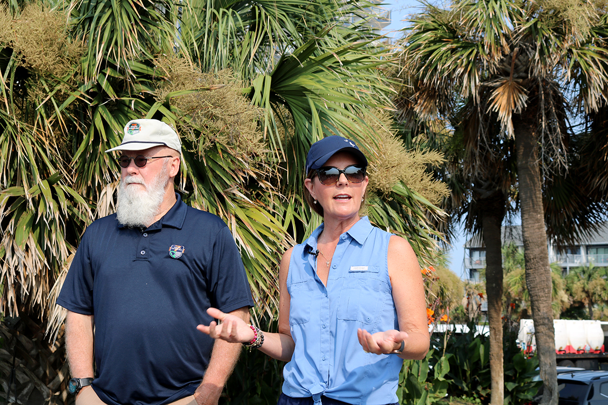 Lt. Gov. Pamela Evette speaks to volunteers at a beach cleanup alongside Dr. Tom Mulligan.