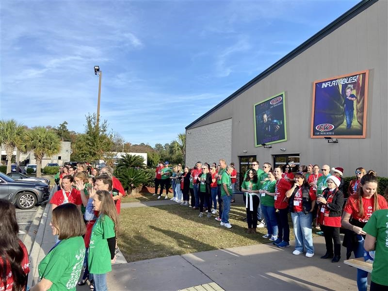 Substitutes for Santa volunteers await students outside the Fun Warehouse in Surfside Beach, S.C.,  for an evening of fun and games followed by shopping at the nearby Walmart.